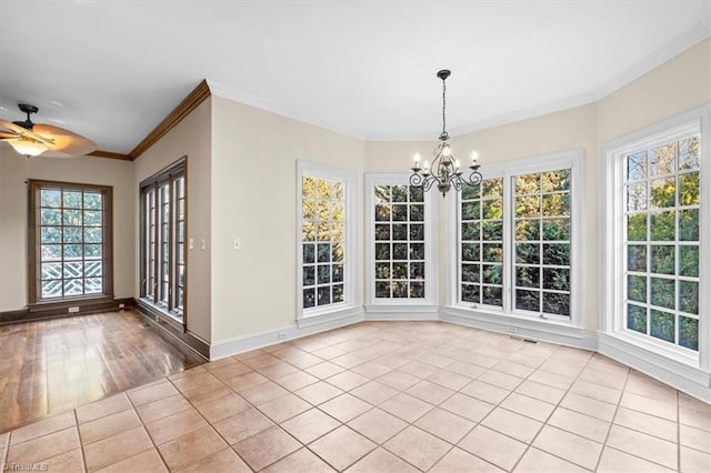 unfurnished dining area featuring ceiling fan with notable chandelier, ornamental molding, and light tile patterned floors