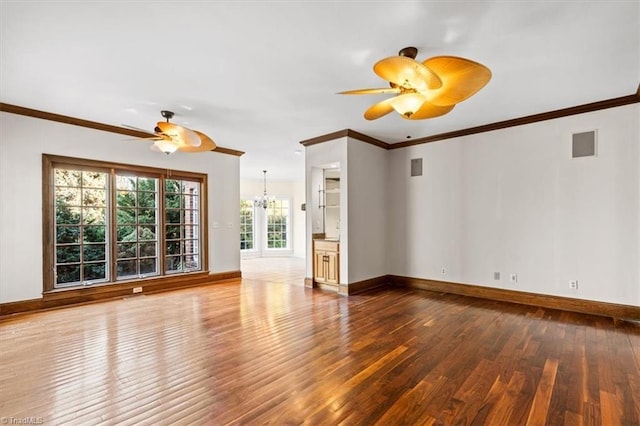 unfurnished living room with ornamental molding, ceiling fan with notable chandelier, and hardwood / wood-style flooring