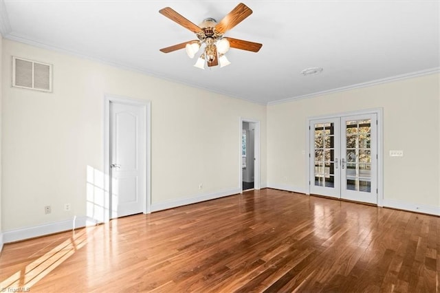 unfurnished room with ornamental molding, ceiling fan, french doors, and hardwood / wood-style floors