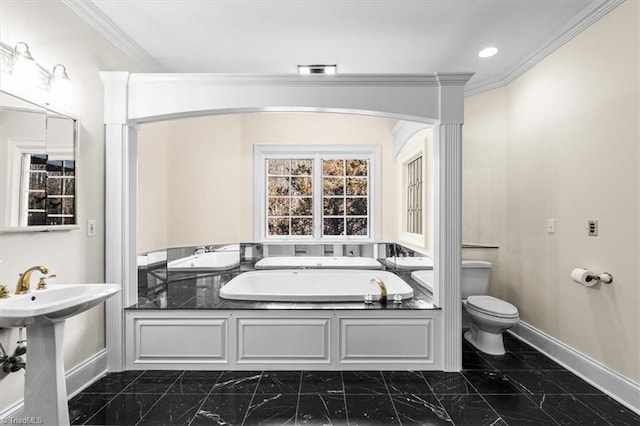 bathroom featuring ornamental molding, a tub, sink, and toilet