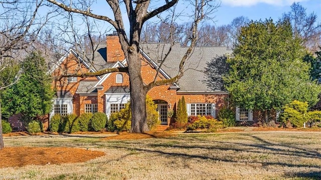 tudor home with a front yard