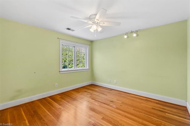 spare room featuring light wood-type flooring and ceiling fan