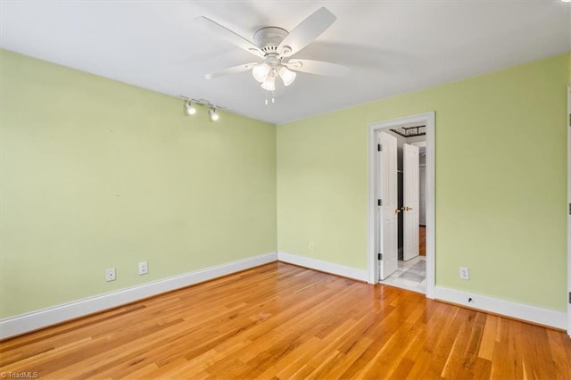 spare room featuring ceiling fan and light hardwood / wood-style floors