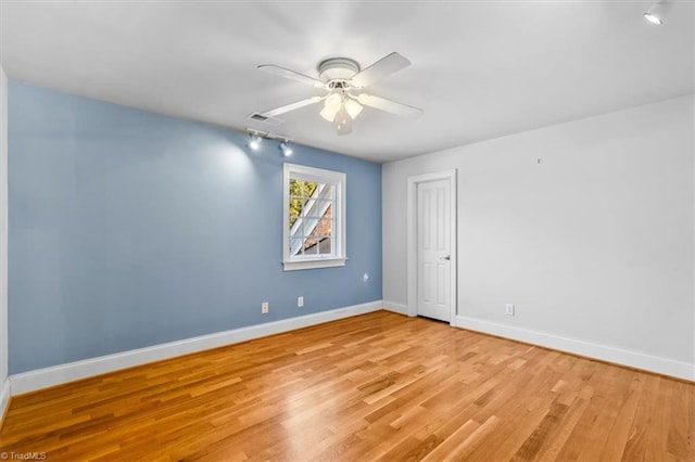 empty room with ceiling fan and light hardwood / wood-style floors