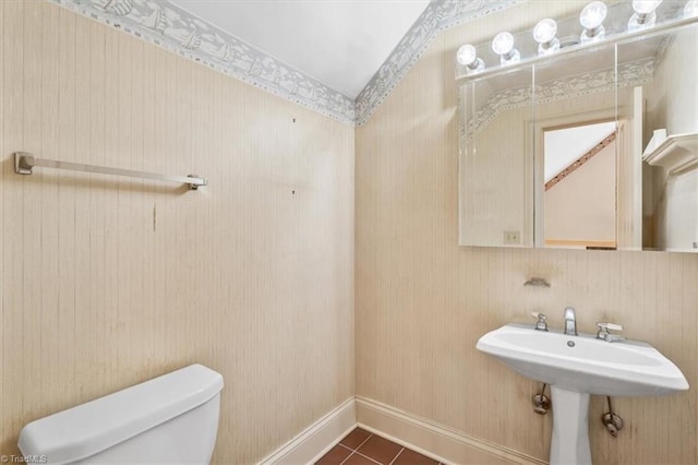 bathroom featuring toilet, tile patterned floors, and sink