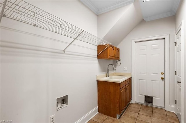 washroom with washer hookup, light tile patterned floors, cabinets, ornamental molding, and sink