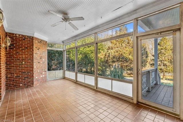 unfurnished sunroom with ceiling fan