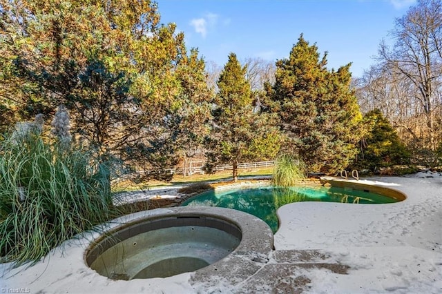 view of pool featuring an in ground hot tub