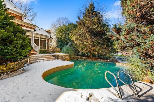 view of pool with a sunroom