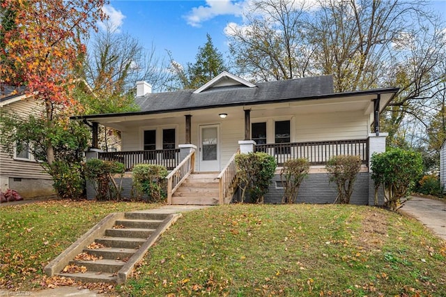 bungalow with covered porch and a front yard