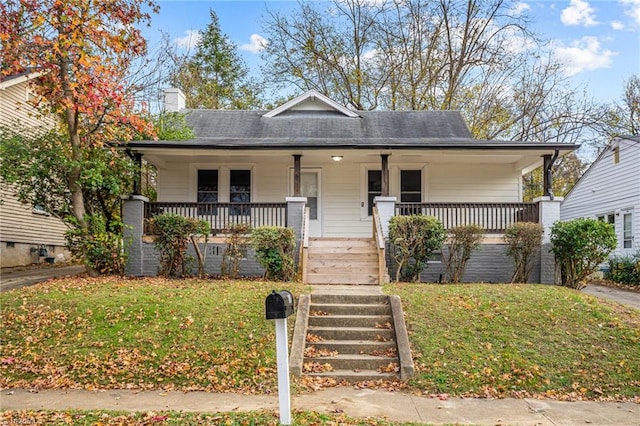 bungalow-style home with a porch and a front lawn