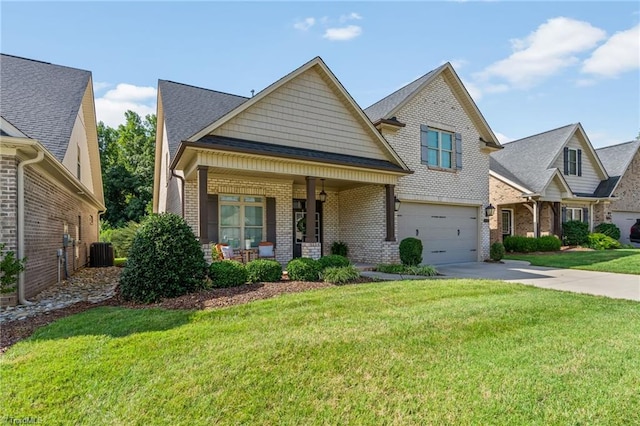 view of front of home with a porch, an attached garage, brick siding, driveway, and a front lawn