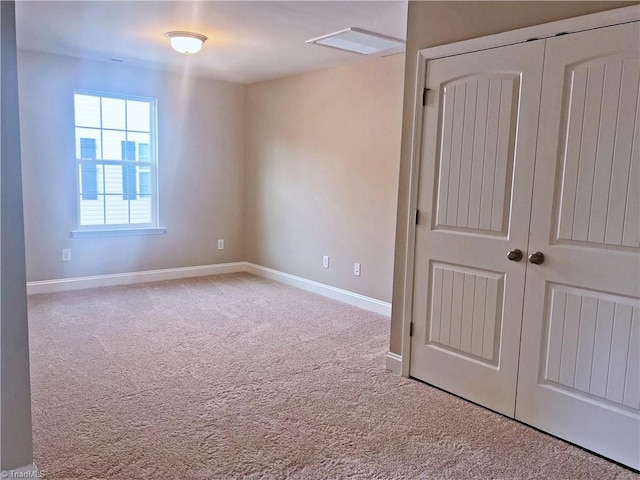 unfurnished bedroom with carpet floors, a closet, and baseboards