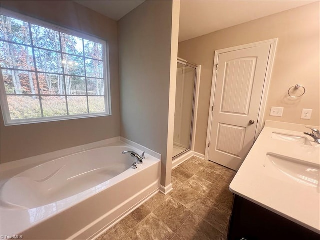 bathroom with a sink, a shower stall, and a bath