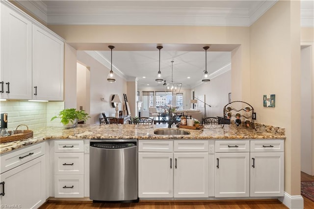 kitchen with a peninsula, a sink, white cabinets, stainless steel dishwasher, and crown molding