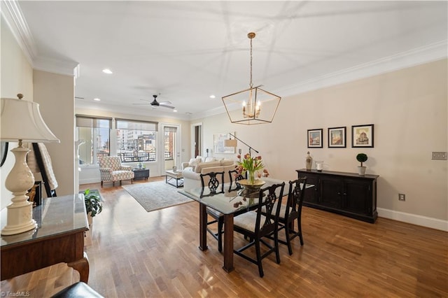 dining area featuring baseboards, ornamental molding, recessed lighting, wood finished floors, and a ceiling fan