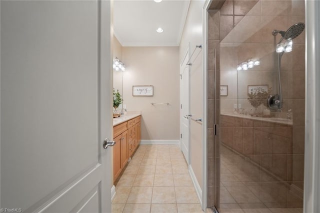 full bathroom with tile patterned floors, a stall shower, ornamental molding, baseboards, and vanity