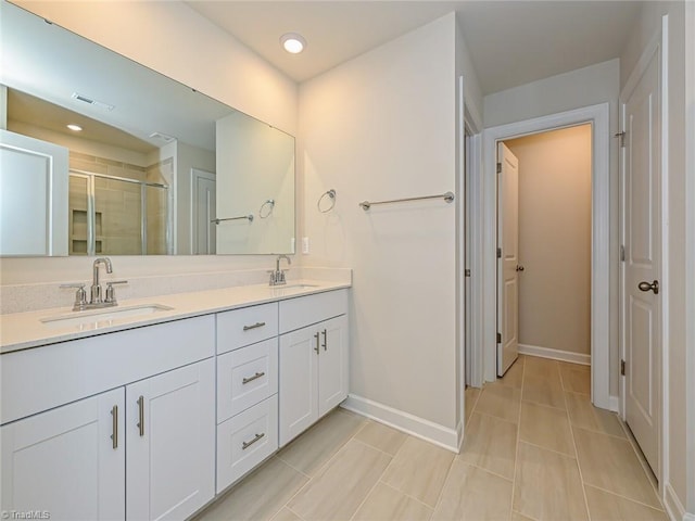 bathroom with tile patterned flooring, vanity, and an enclosed shower