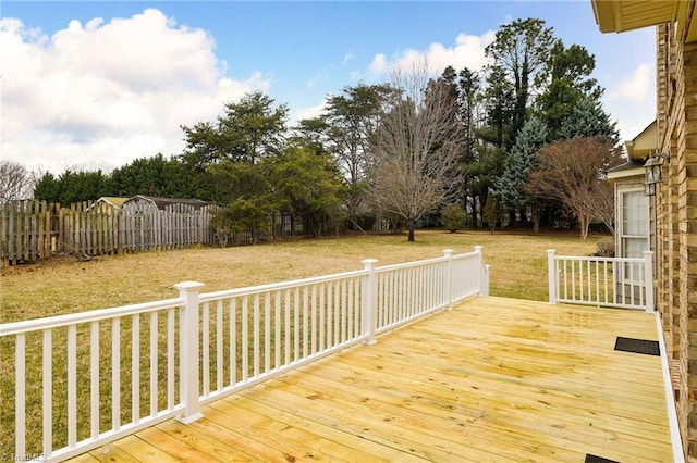 wooden deck featuring a lawn