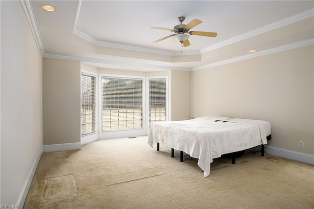 carpeted bedroom with crown molding, a raised ceiling, and ceiling fan