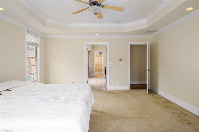 carpeted bedroom featuring crown molding, ceiling fan, and a tray ceiling