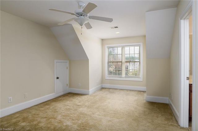 bonus room with vaulted ceiling, light colored carpet, and ceiling fan