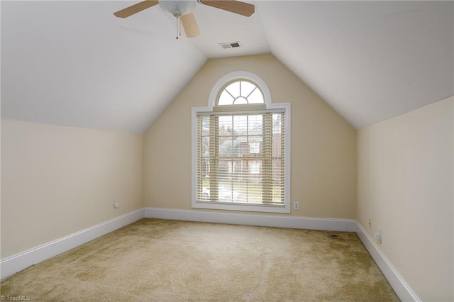 bonus room with ceiling fan, vaulted ceiling, and light carpet