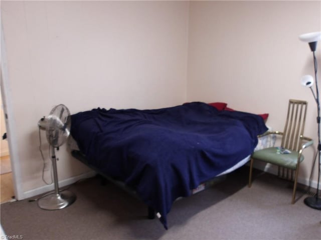 bedroom with carpet flooring and baseboards