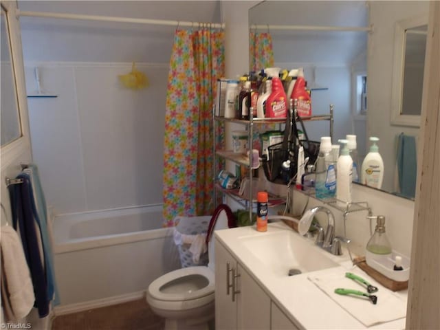 bathroom featuring shower / bathtub combination with curtain, toilet, and vanity