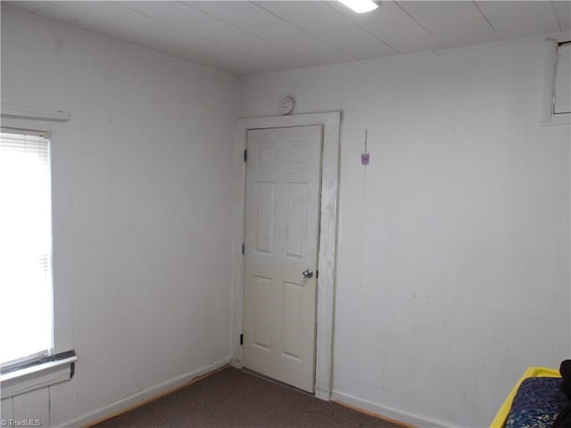 unfurnished room featuring plenty of natural light and baseboards