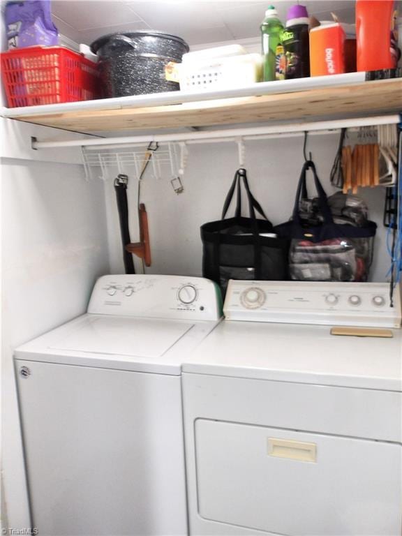 clothes washing area featuring washer and clothes dryer