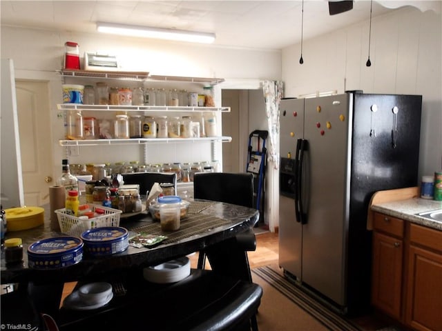 kitchen with brown cabinets and stainless steel refrigerator with ice dispenser