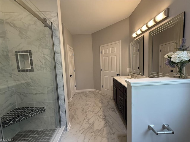bathroom with marble look tiles, a shower stall, vanity, and baseboards