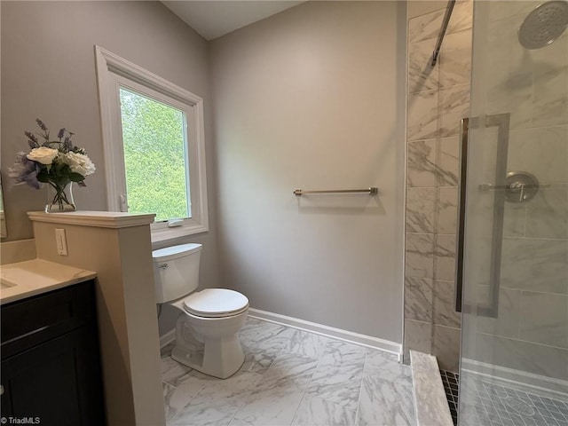 bathroom with marble finish floors, tiled shower, toilet, vanity, and baseboards