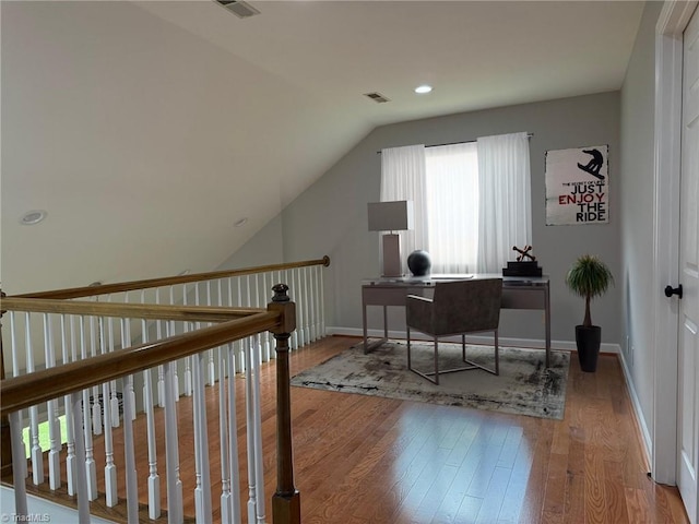 office space with hardwood / wood-style floors, vaulted ceiling, baseboards, and recessed lighting