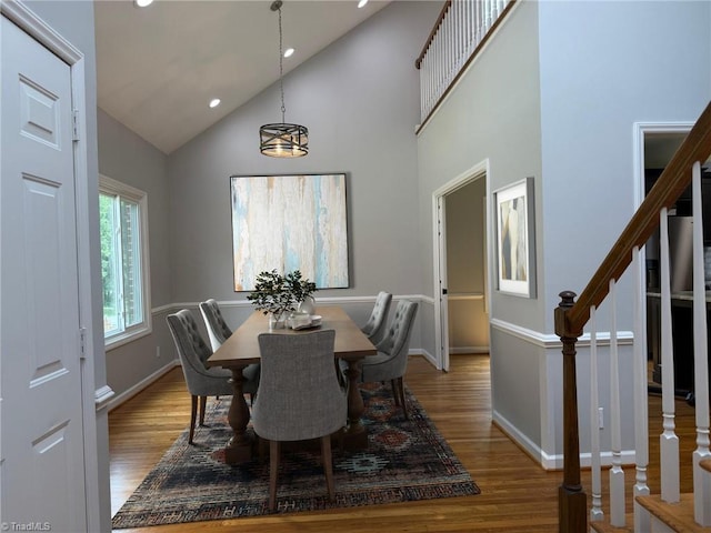 dining room featuring high vaulted ceiling, light wood finished floors, stairway, recessed lighting, and baseboards