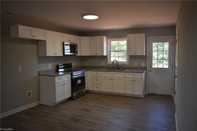 kitchen featuring dark wood-type flooring, stainless steel appliances, sink, light stone counters, and white cabinets