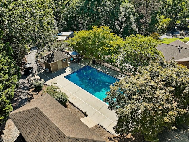 view of pool with an outbuilding and a patio area