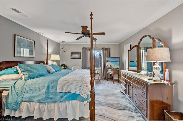 bedroom with multiple windows, ceiling fan, and ornamental molding