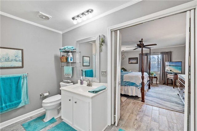 bathroom featuring ceiling fan, toilet, crown molding, and vanity