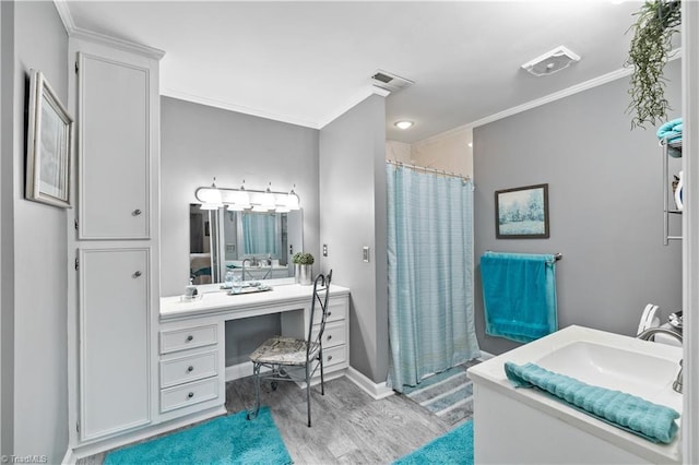 bathroom with wood-type flooring, vanity, walk in shower, and ornamental molding