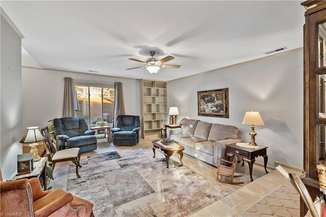 living room featuring built in shelves and ceiling fan