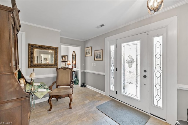 foyer entrance featuring ornamental molding and a wealth of natural light