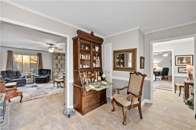 sitting room with ceiling fan and crown molding