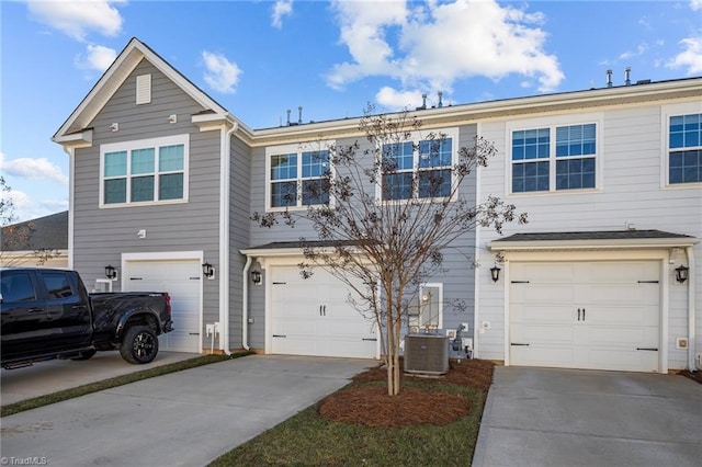 view of front of home featuring a garage and central air condition unit