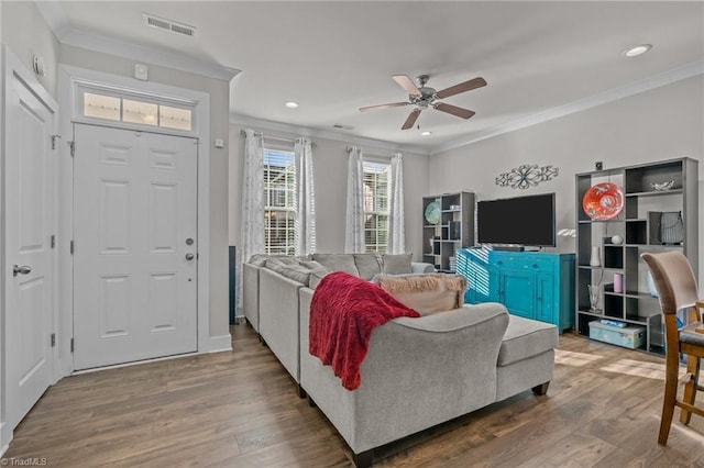 living room featuring crown molding, ceiling fan, and wood-type flooring