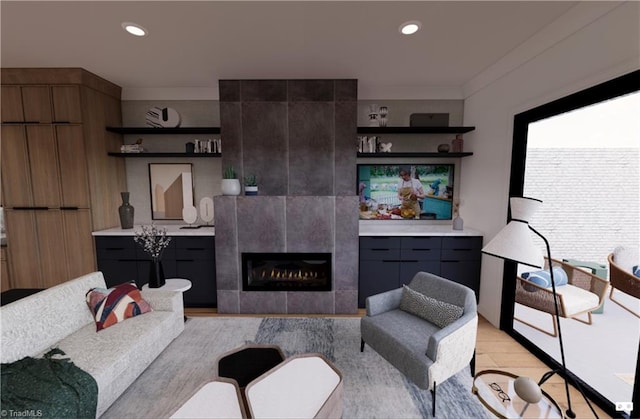 living room featuring light hardwood / wood-style flooring and a tiled fireplace