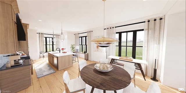 dining area featuring french doors, sink, and light hardwood / wood-style flooring