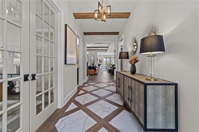 corridor featuring an inviting chandelier, baseboards, beam ceiling, and french doors