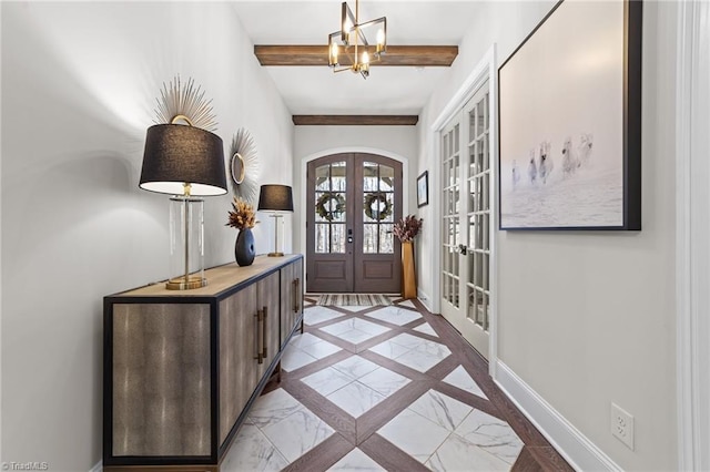 entrance foyer featuring arched walkways, a chandelier, baseboards, french doors, and beamed ceiling